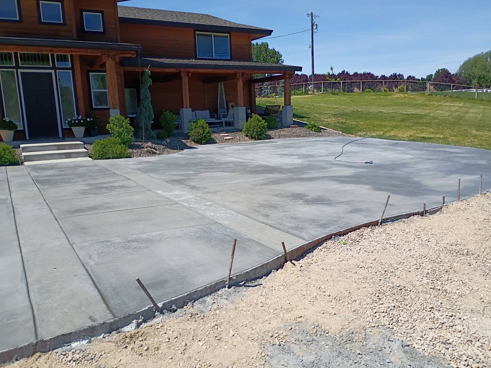 Wide concrete driveway with side patio Treasure Valley